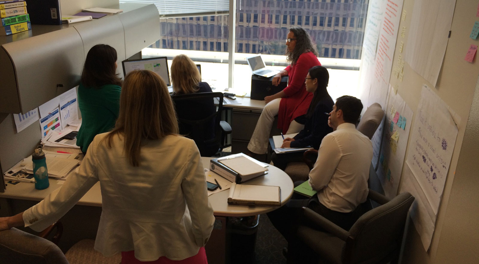 A team of people look at a demo of College Scorecard